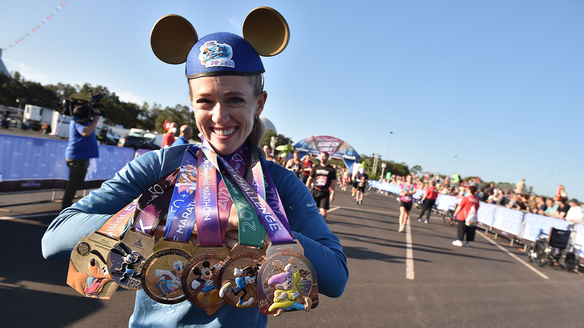 Ultrarunner Brittany Charboneau standing with her disney medals